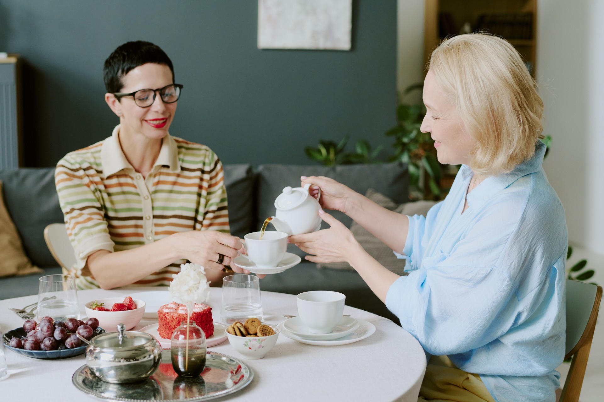 Luxury high tea gathering with women from all ethnicities dressed in purple 